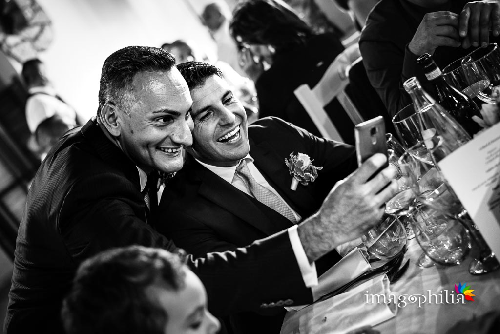 Risate tra i tavoli durante il ricevimento di matrimonio presso la Tenuta Colle degli Ulivi di Palombara Sabina / 1