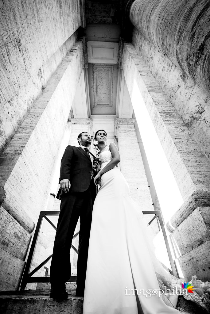 Post matrimonio: gli sposi sbirciano in mezzo al colonnato del Bernini a Piazza San Pietro a Roma